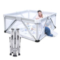 White playpen with a child inside .