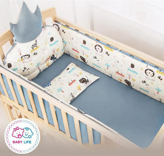 Baby crib with colorful bedding and shark-shaped pillow, featuring the 'Baby Life' brand logo.