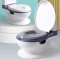 Children's toilet seat with gray base and white seat on a toilet .