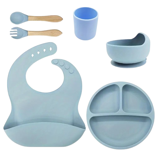 Set of blue silicone baby utensils including a bib, plate, cup, and spoons .