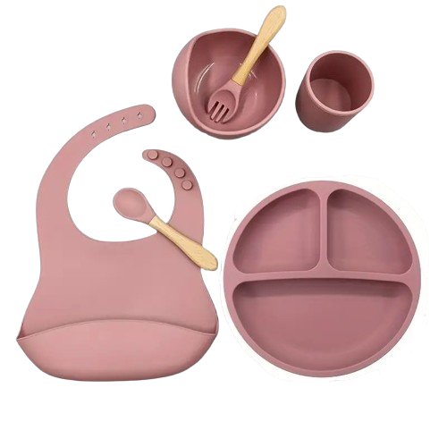 Pink baby silicone feeding set with bib, bowl, cup, and plate .