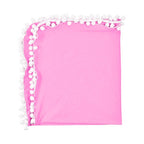 Pink blanket with white pom-pom trim .
