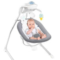 Baby in a gray baby electric musical swing with colorful toys 