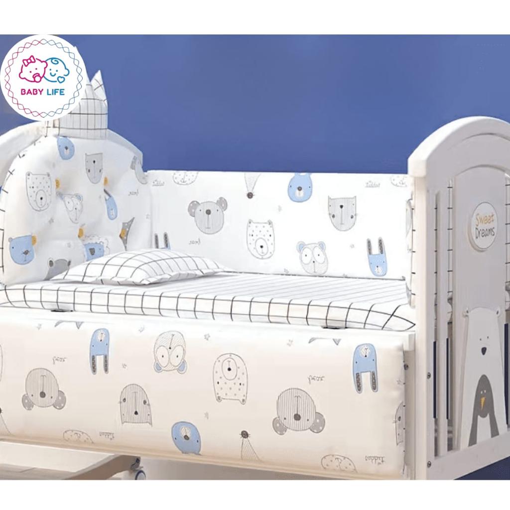 Children's crib with five piece bedding cartoon animal pattern and 'Baby Life' branding.