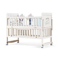 Wooden White crib with baby blankets 
