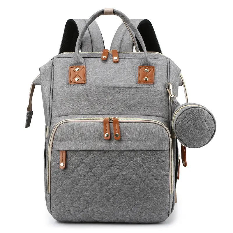Gray backpack with quilted design and brown leather accents .