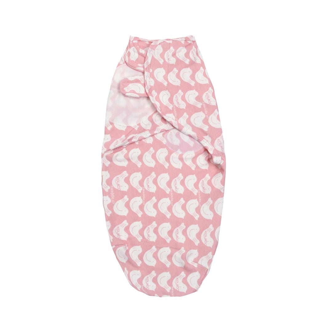 Pink baby swaddle with white patterns .