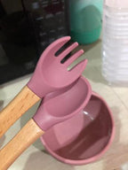 Pink  silicone spoon and wooden handle utensils .