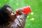 Child drinking from a Melii spikey water bottles.