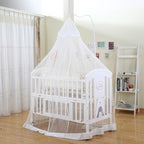 White crib with a canopy in a room with curtains and a bookshelf.
