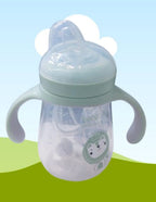 Baby bottle with a cartoon character label on a light blue and green gradient 