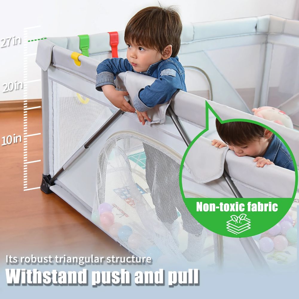 Child playing inside a portable playpen with non-toxic fabric label .