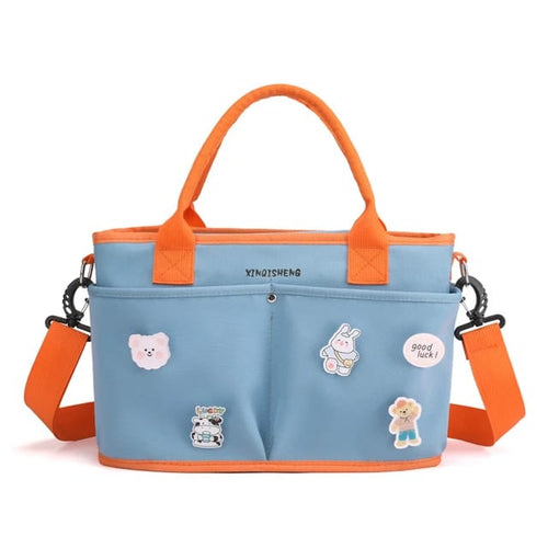 Blue bag with orange handles and strap