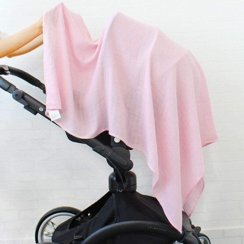 Black stroller with a pink swaddle blanket