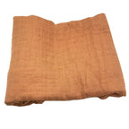 Folded orange bamboo cotton swaddle blanket