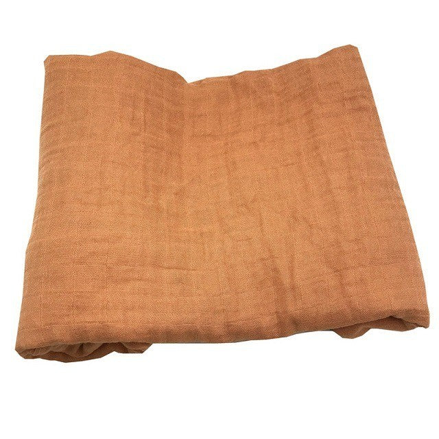 Folded orange bamboo cotton swaddle blanket