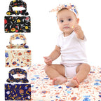 Baby sitting on a floral blanket with floral headbands 