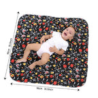 Baby lying on a floral-patterned mat with dimensions indicated
