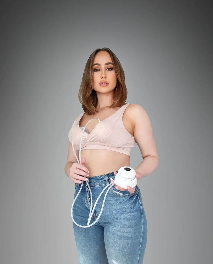 Woman holding 3 in 1 breast pump revolution double wearable automatic and usb chargeable.