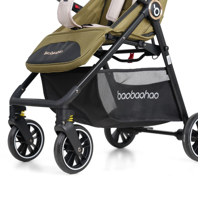Close-up of a baby stroller with an olive green and black seat liner, black frame, and a black mesh storage basket .