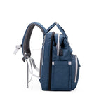 Blue backpack diaper bag with multiple pockets and straps .