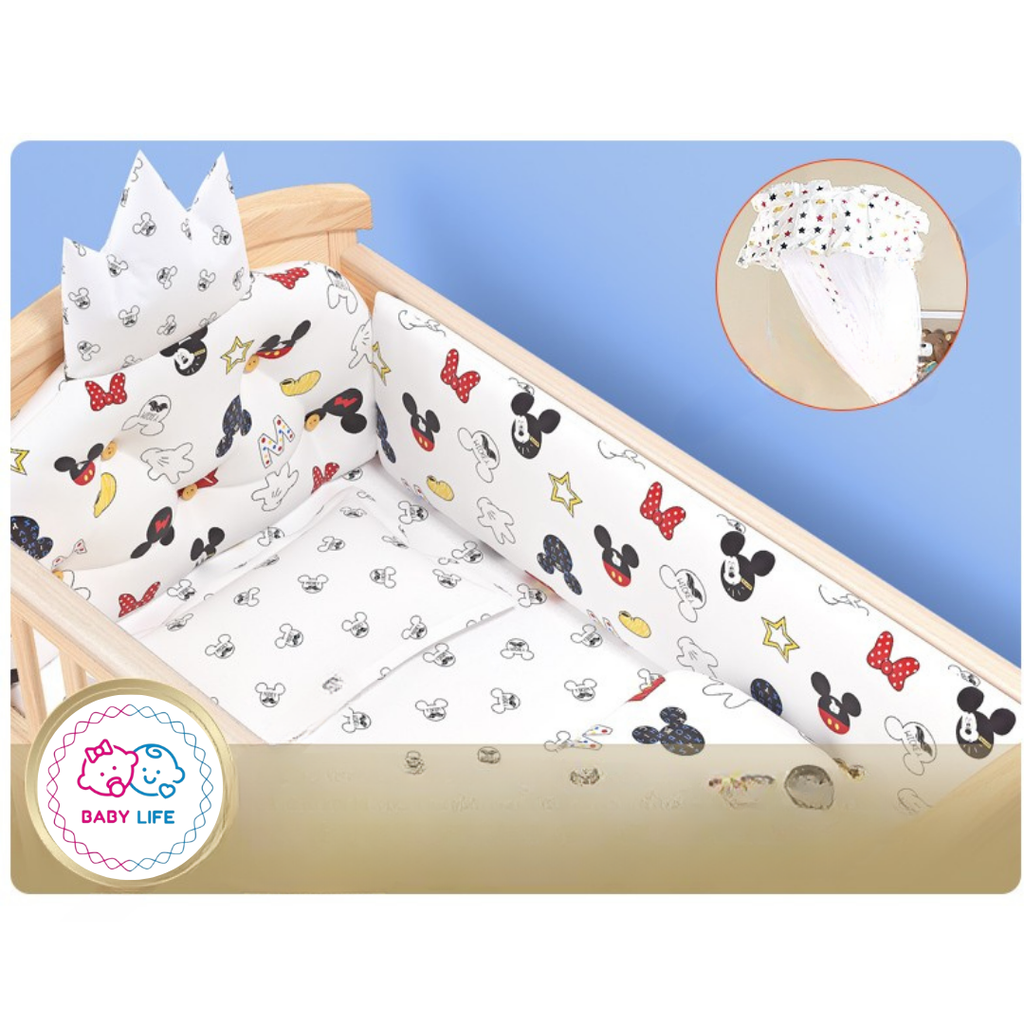 Baby crib with Mickey Mouse-themed bedding set .