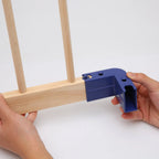 Blue corner connector being used on wooden frames.
