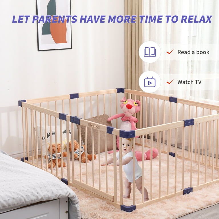 Wooden playpen with a child inside, toys around.
