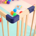 Baby gate corner protector with colorful balls on a playpen.