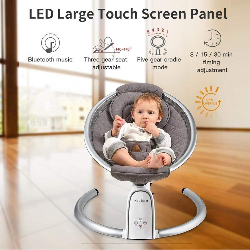 Baby in a gray baby swing with LED large touch screen panel features displayed.