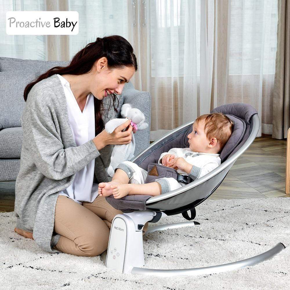 Woman interacting with a baby in a baby bouncer. Hot Mom cotton electric babyBouncer..with Bluetooth