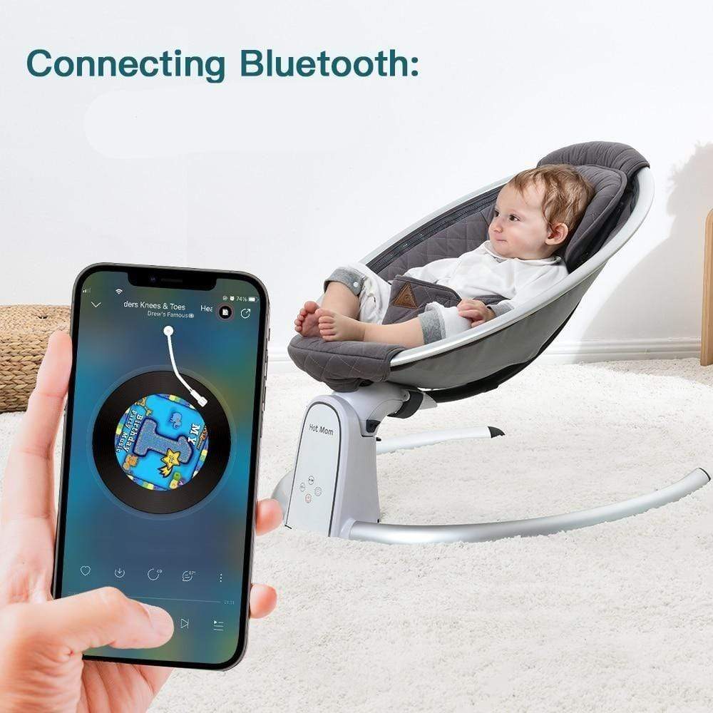 Baby in a modern electric baby bouncer connected to a smartphone app 