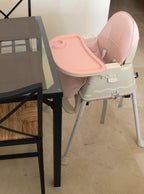 Pink and beige high chair .