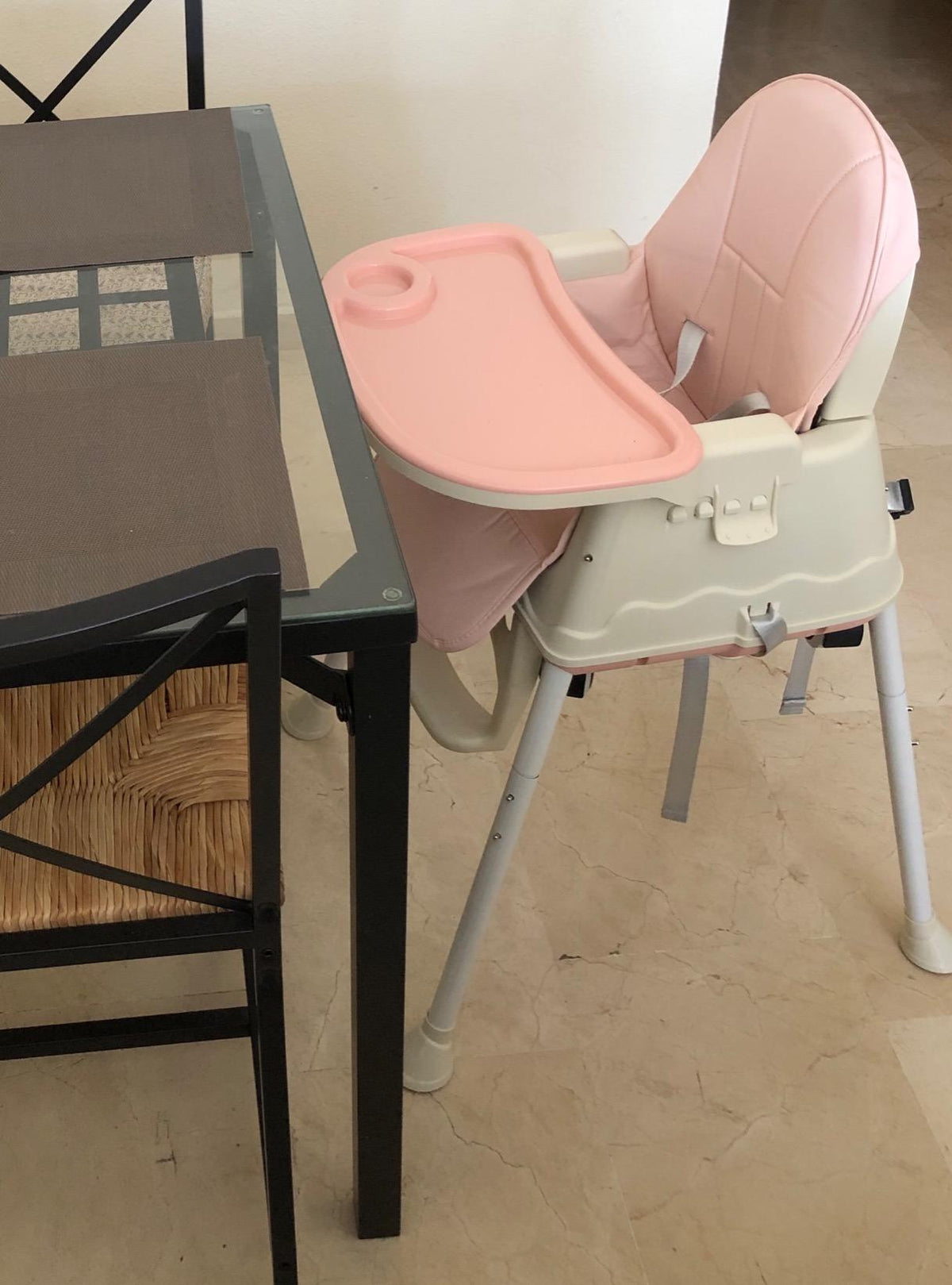 Pink and beige high chair .
