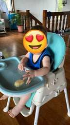 Child in a high chair with a blue tray