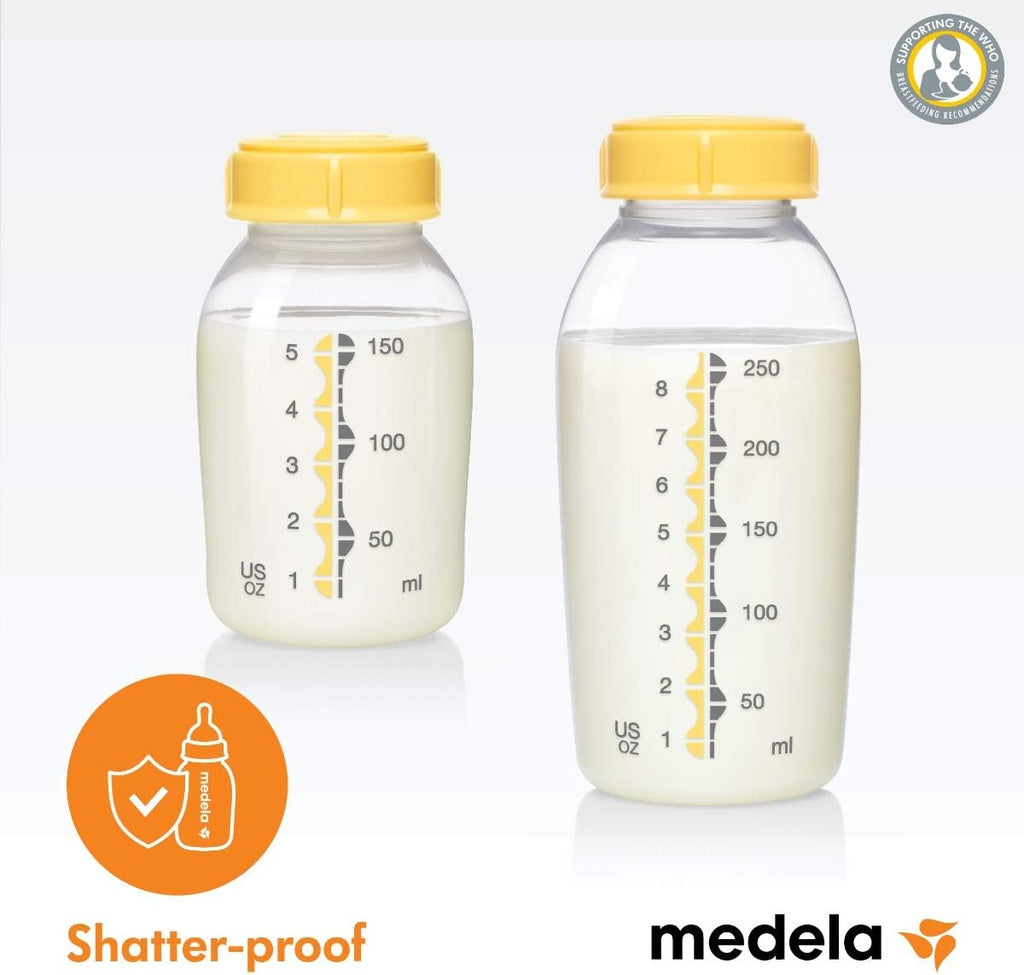 Two Medela breast milk storage bottles with yellow lids.
