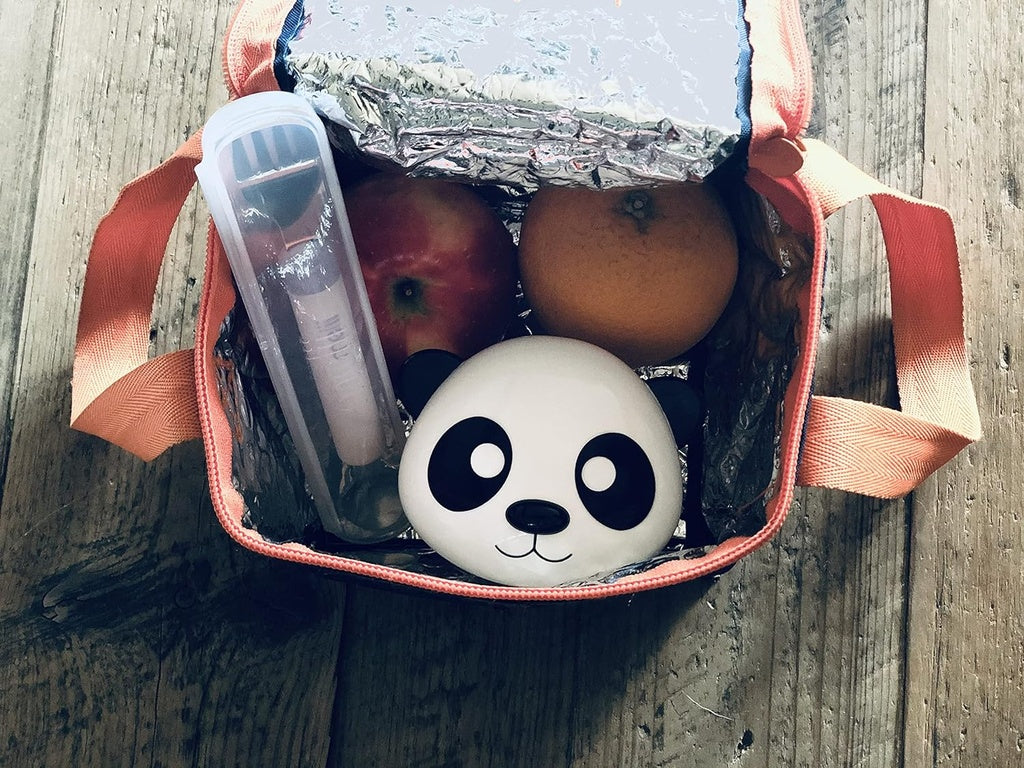 Panda-shaped Melii container with fruits and a bottle in a transparent bag .