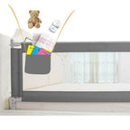 Gray baby crib safety rail with toys.