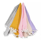 Set of five scarves in different colors with pom-pom 