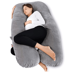 Woman lying on a pregnancy U-shaped gray pillow 