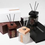 Collection of diffusers including a black one, a white one with wooden top, and a brown one.