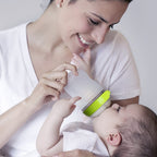Woman feeding a baby with a Como Tomo Natural silicone  bottle.