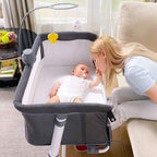 Baby in a portable  baby bassinet 