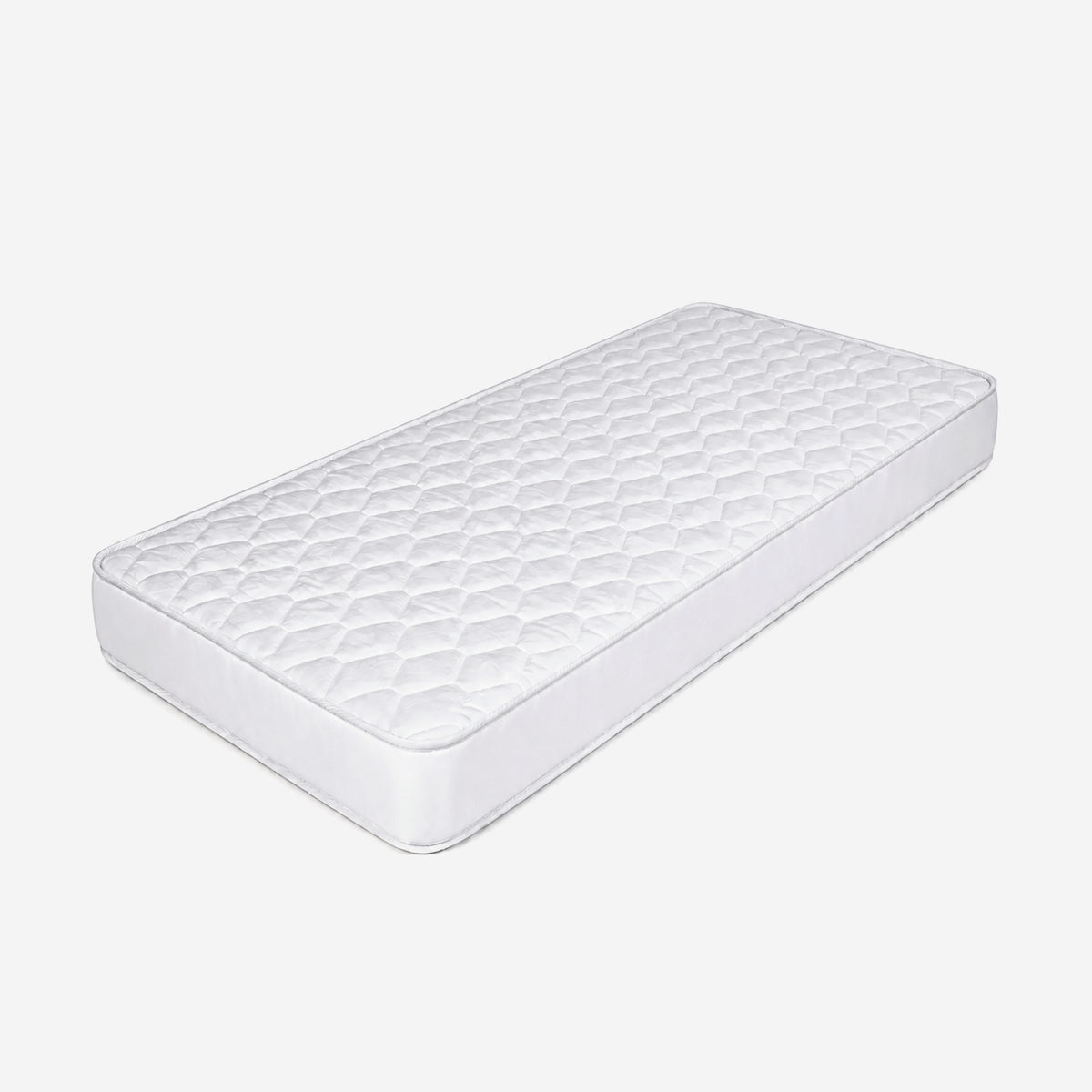 A white quilted mattress topper or mattress pad with a diamond-patterned .